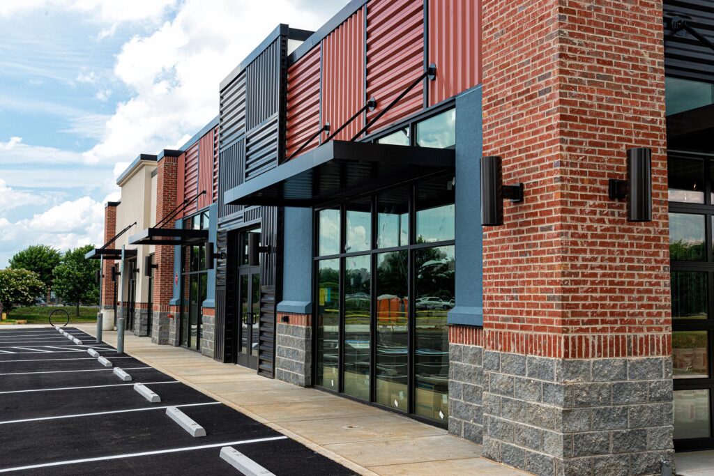 Horizontal shot of a new strip shopping center almost ready to open.