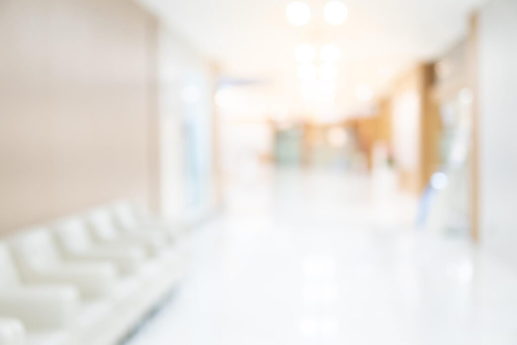 Abstract blur luxury hospital corridor. Blur clinic interior background with defocused effect. Healthcare and medical concept